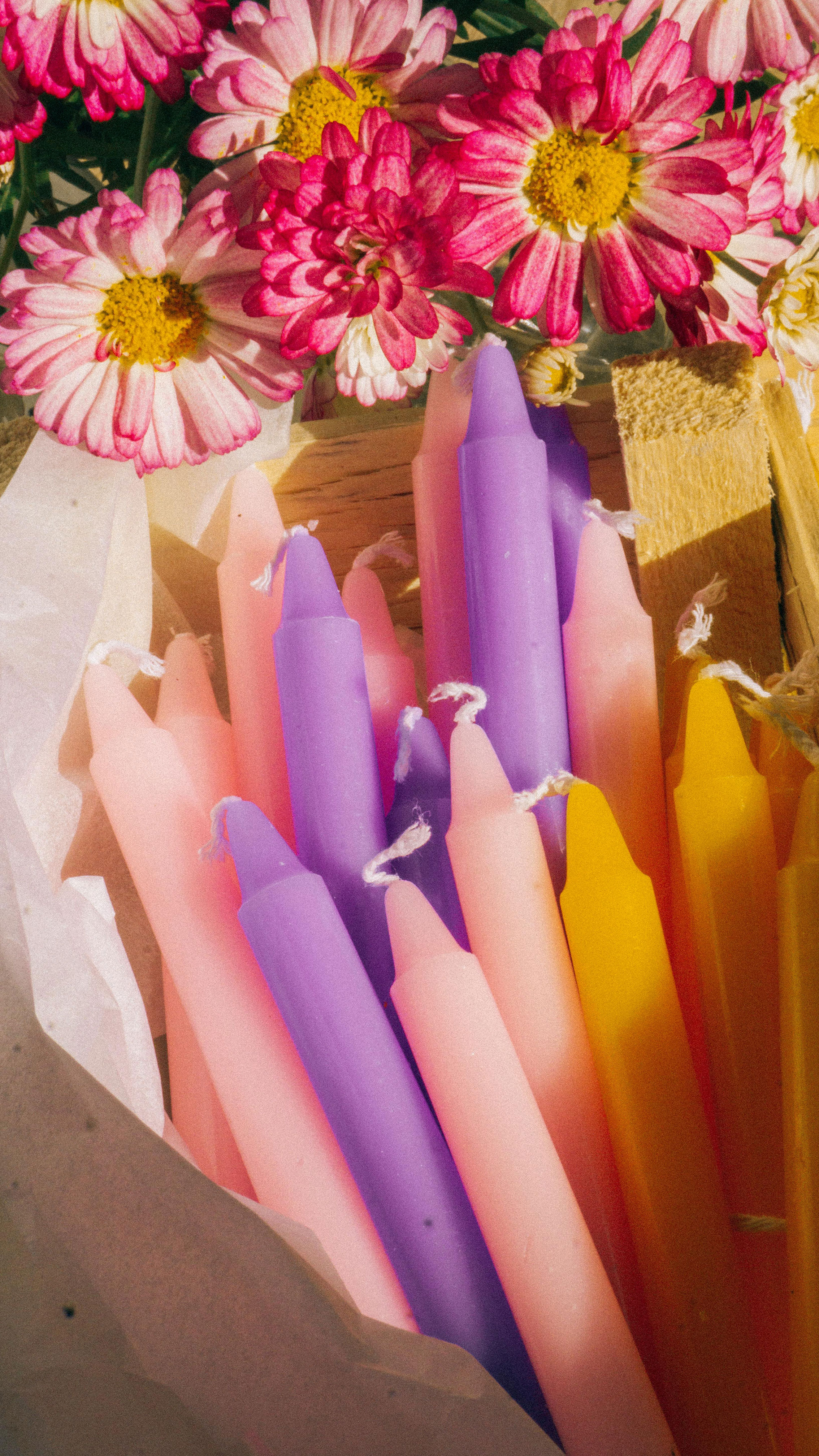 long candles in different colours like pink,purple and orange representing spring made in Canada