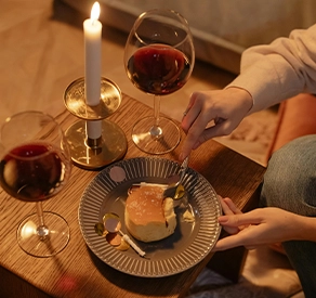 sheniqua scented candles hosting an event call laugh and sip, litted scented eco freindly candles and red wine
